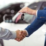 Dealer handing keys to a customer