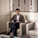 Man waiting at a Jaguar dealership lounge