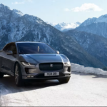 Jaguar I-PACE driving in winter conditions with mountains